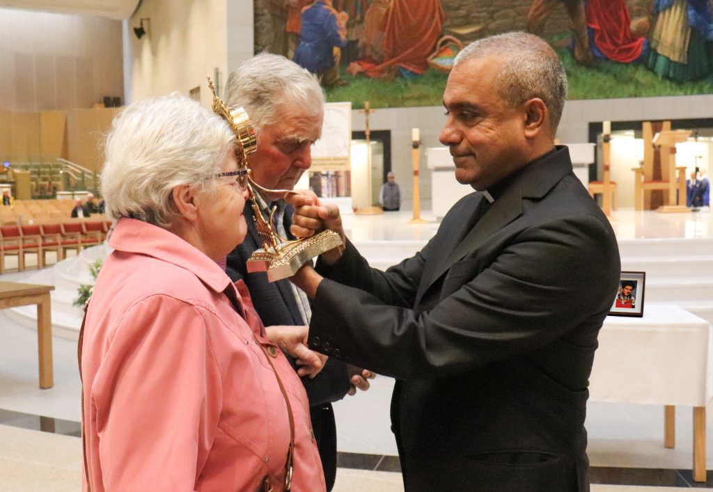 14. Monsignor Anthony Figueiredo blesses a couple with the Relic of Blessed Carlo Acutis at Knock Shrine